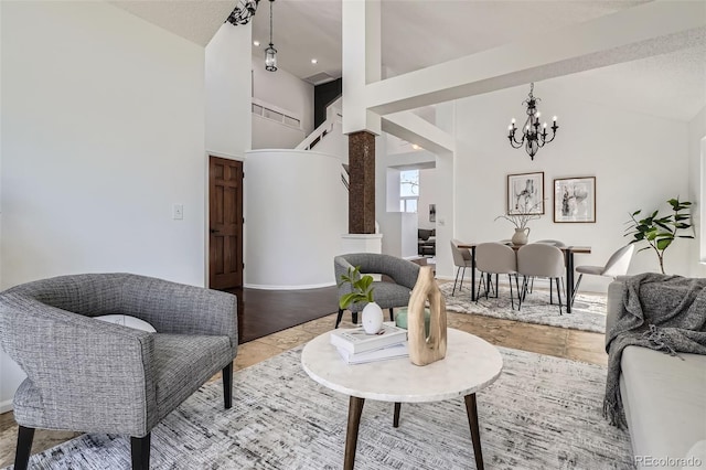 living area featuring a notable chandelier and high vaulted ceiling