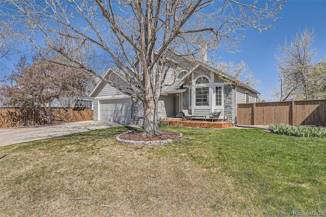 view of front of house featuring fence, a front yard, a gate, concrete driveway, and an attached garage