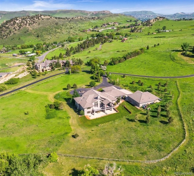 drone / aerial view with a mountain view and a rural view