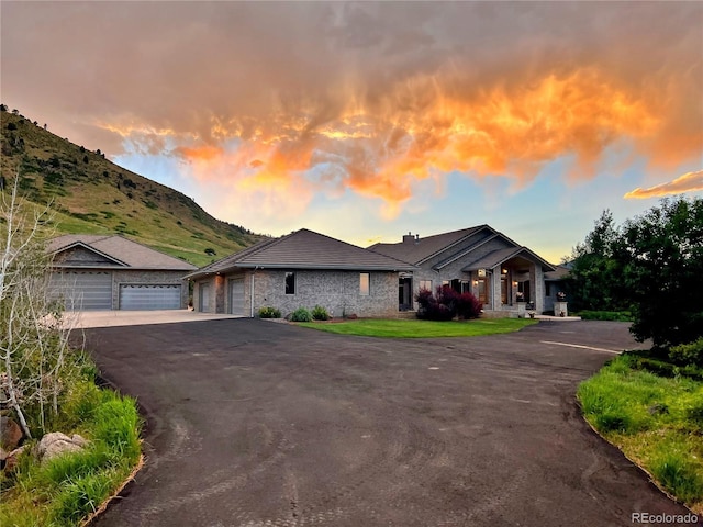 view of front facade featuring a mountain view and a garage