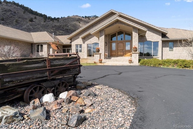 5881 Deer Meadow Trl, Golden, CO 80403 - back of property featuring brick siding and a mountain view