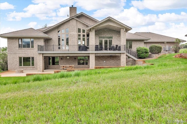 5881 Deer Meadow Trl, Golden, CO 80403 - back of property with a patio, a chimney, brick siding, stairway, and a balcony