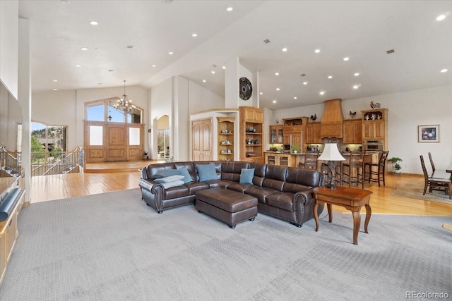 5881 Deer Meadow Trl, Golden, CO 80403 - living room with light wood-style floors, high vaulted ceiling, a chandelier, recessed lighting, and arched walkways