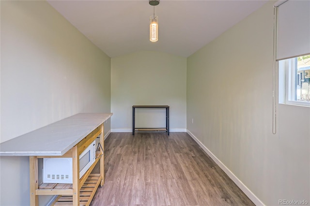 empty room featuring hardwood / wood-style floors and lofted ceiling