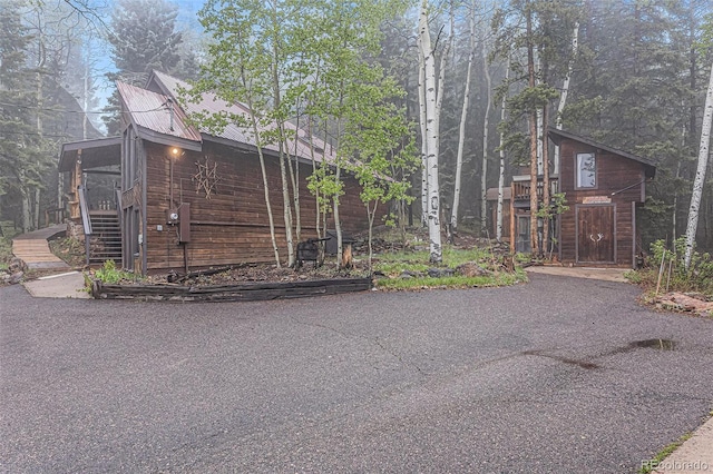 10419 Christopher Dr, Conifer, CO 80433 - view of property exterior with stairs and metal roof