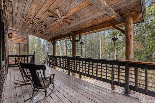10419 Christopher Dr, Conifer, CO 80433 - deck with a ceiling fan and view of wooded area