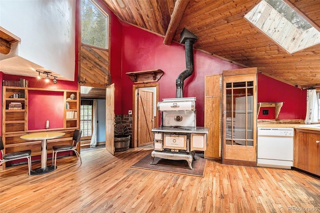 10419 Christopher Dr, Conifer, CO 80433 - kitchen with dishwasher, a wood stove, hardwood / wood-style floors, wood ceiling, and healthy amount of natural light