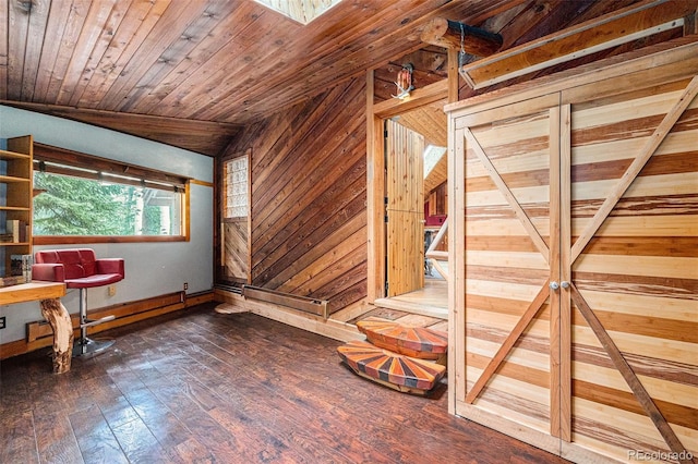 10419 Christopher Dr, Conifer, CO 80433 - spare room featuring wooden walls, dark wood finished floors, lofted ceiling, baseboards, and wooden ceiling