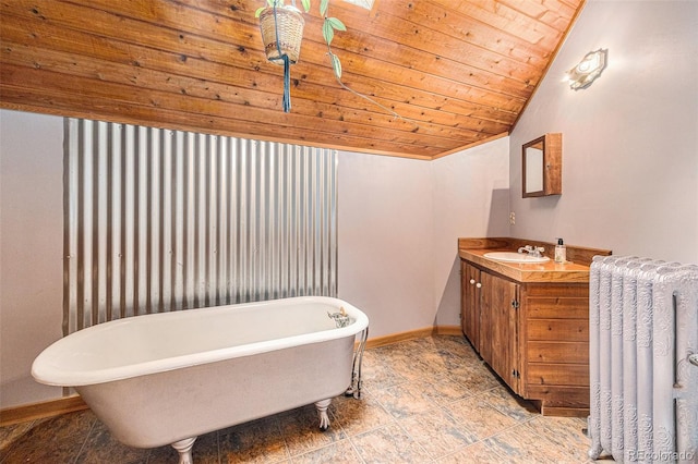 10419 Christopher Dr, Conifer, CO 80433 - bathroom with radiator, baseboards, vanity, vaulted ceiling, and a soaking tub