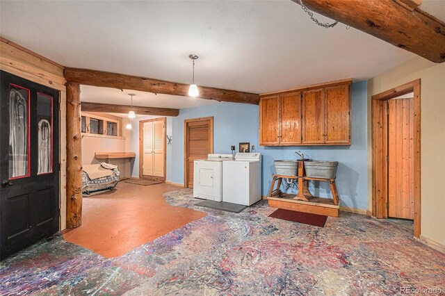 10419 Christopher Dr, Conifer, CO 80433 - kitchen featuring separate washer and dryer, baseboards, brown cabinets, beamed ceiling, and pendant lighting