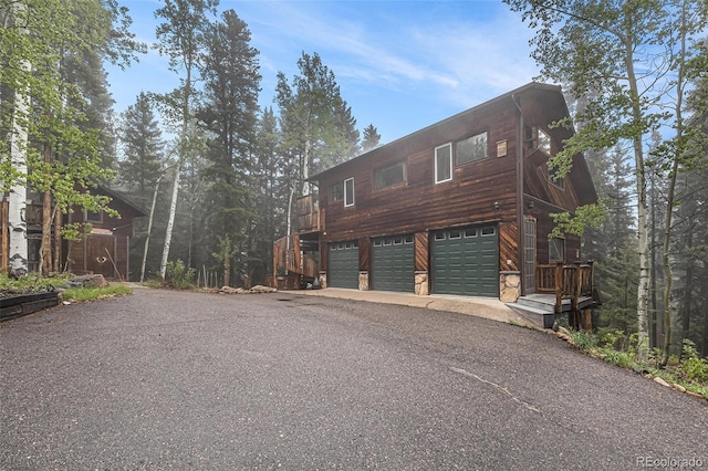 10419 Christopher Dr, Conifer, CO 80433 - view of home's exterior featuring a garage and asphalt driveway