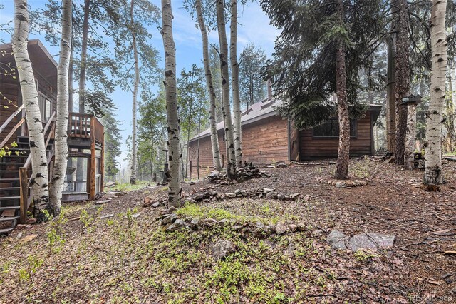 10419 Christopher Dr, Conifer, CO 80433 - view of yard featuring stairway and a wooden deck
