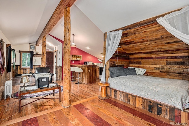 10419 Christopher Dr, Conifer, CO 80433 - bedroom with lofted ceiling, wood walls, hardwood / wood-style floors, and radiator heating unit
