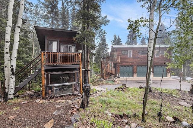 10419 Christopher Dr, Conifer, CO 80433 - rear view of property with stairs, a garage, and driveway
