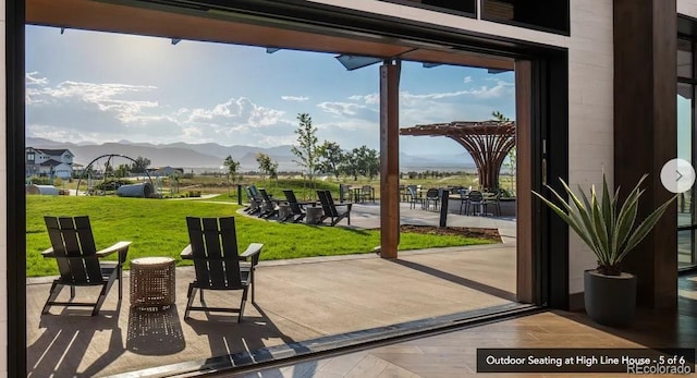 doorway to outside with a mountain view and wood finished floors