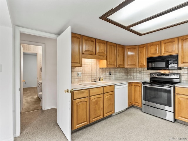 kitchen with a sink, white dishwasher, stainless steel range with electric stovetop, black microwave, and light countertops