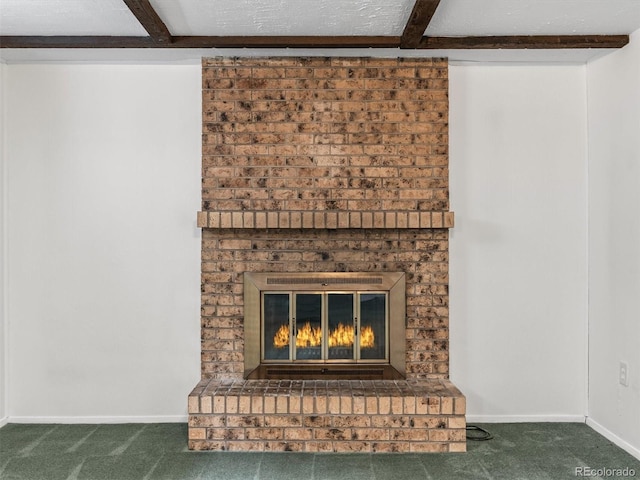 interior details with baseboards, beam ceiling, a brick fireplace, and carpet