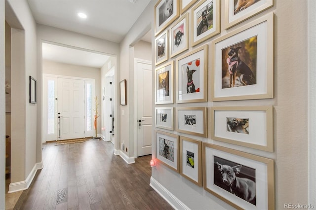 interior space featuring recessed lighting, baseboards, and dark wood finished floors