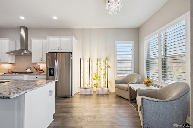 14160 Ivanhoe St, Thornton, CO 80602 - kitchen featuring appliances with stainless steel finishes, wall chimney exhaust hood, dark wood-style floors, white cabinets, and recessed lighting
