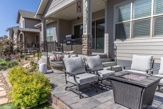 14160 Ivanhoe St, Thornton, CO 80602 - view of patio featuring an outdoor living space with a fire pit