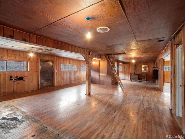 basement with wood walls, wooden ceiling, and hardwood / wood-style flooring