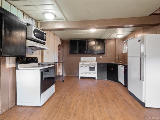 kitchen featuring white appliances, sink, light wood-type flooring, range hood, and beamed ceiling