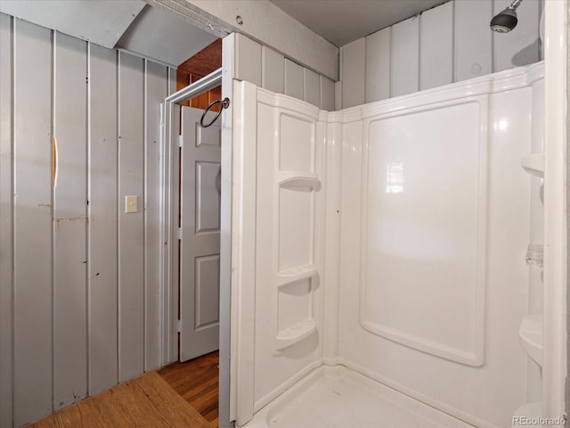 bathroom featuring wood-type flooring and walk in shower