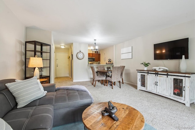 2880 S Locust St Unit 305N, Denver, CO 80222 - living room with carpet floors, a chandelier, and baseboards