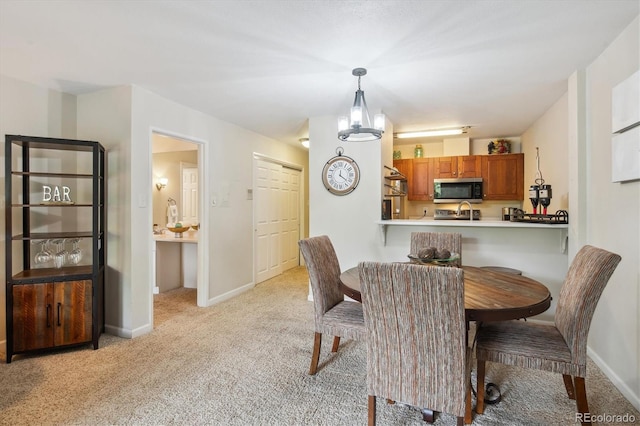 2880 S Locust St Unit 305N, Denver, CO 80222 - dining room featuring light carpet and baseboards
