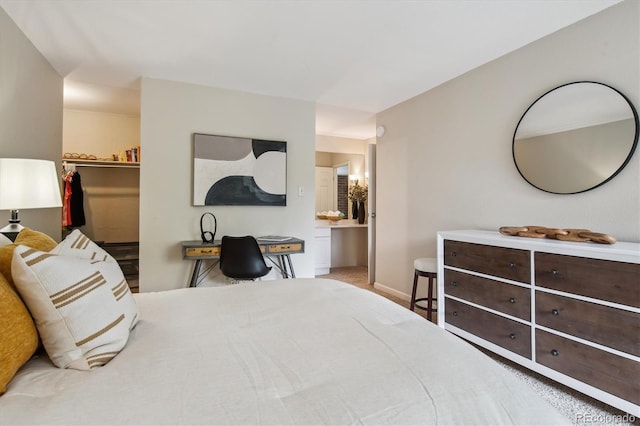 2880 S Locust St Unit 305N, Denver, CO 80222 - bedroom featuring a walk in closet, a closet, and baseboards