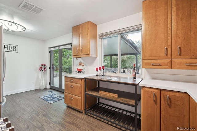 2843 S Otis St, Denver, CO 80227 - kitchen with dark wood finished floors, light countertops, and brown cabinets
