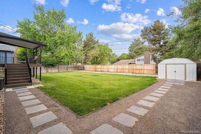 2843 S Otis St, Denver, CO 80227 - fenced backyard featuring a storage shed and stairs