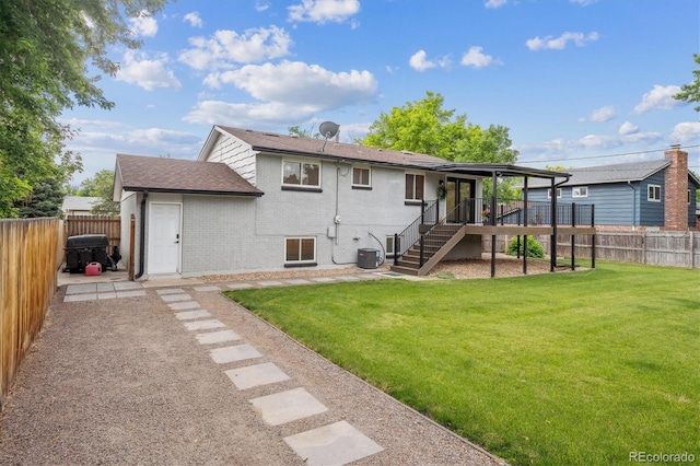 2843 S Otis St, Denver, CO 80227 - rear view of property featuring a fenced backyard, brick siding, stairs, and a shingled roof