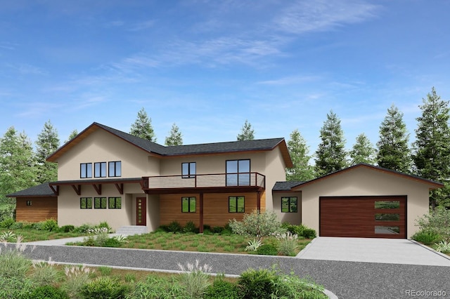 view of front of house featuring a garage, stucco siding, driveway, and a balcony