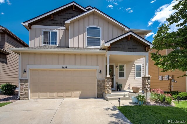 2456 Sierra Springs Dr, Colorado Springs, CO 80916 - craftsman inspired home featuring board and batten siding, stone siding, concrete driveway, and an attached garage