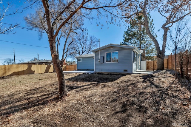 back of property with a fenced backyard