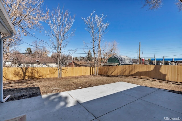 view of patio featuring fence