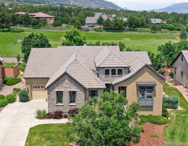 1915 Cantwell Grv, Colorado Springs, CO 80906 - tudor-style house featuring stone siding, stucco siding, driveway, and a mountain view
