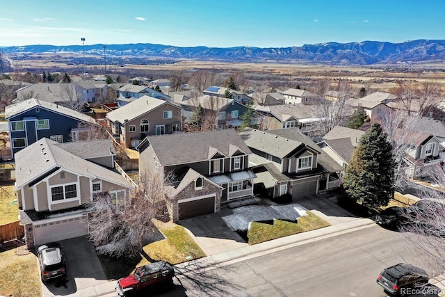 drone / aerial view featuring a residential view and a mountain view