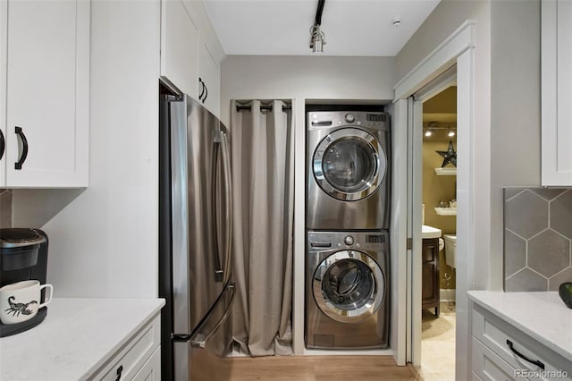 laundry area featuring stacked washing maching and dryer