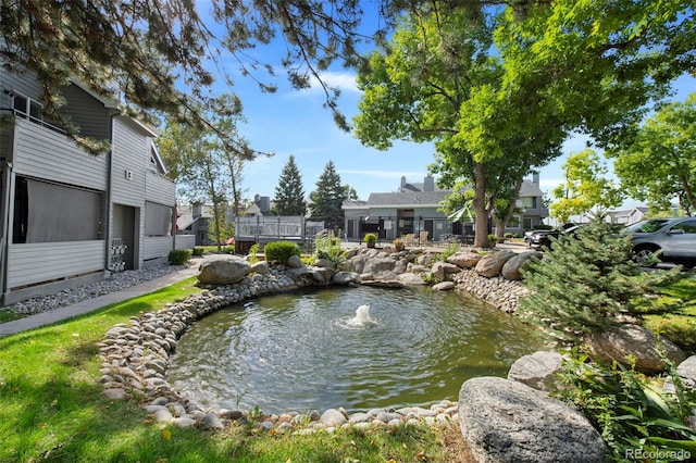 view of home's community featuring a small pond