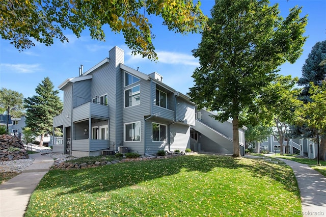 view of side of home with a yard and cooling unit