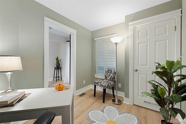 living area with light hardwood / wood-style flooring