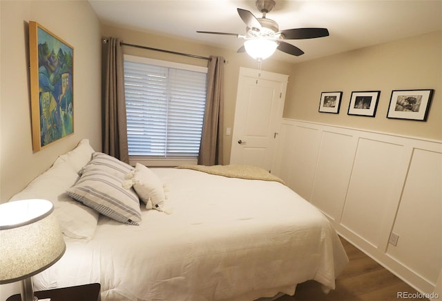 bedroom with ceiling fan and dark hardwood / wood-style flooring