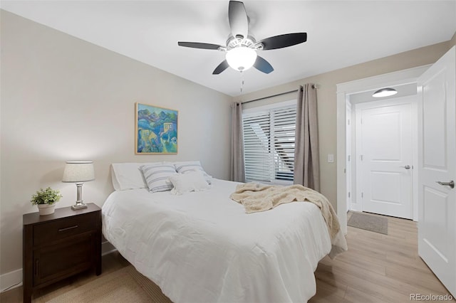 bedroom with light hardwood / wood-style flooring and ceiling fan