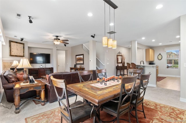 dining area featuring recessed lighting, ceiling fan, light colored carpet, and stairway