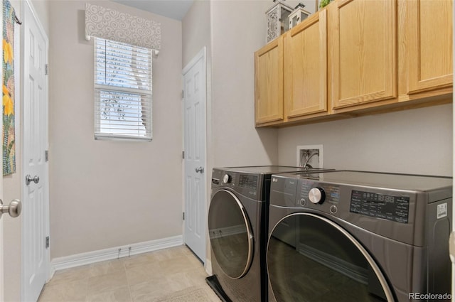 laundry room with separate washer and dryer, baseboards, and cabinet space