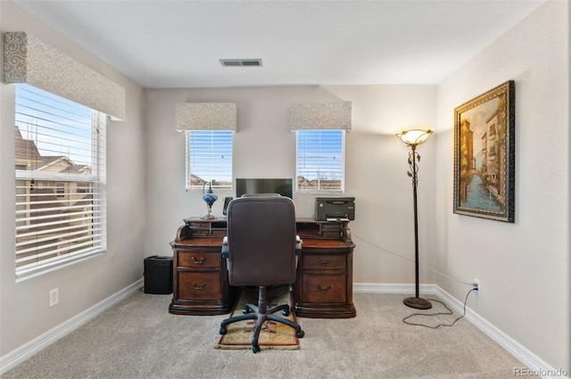 carpeted office space featuring baseboards and visible vents