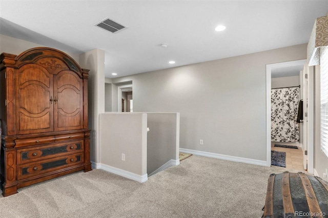 interior space featuring visible vents, recessed lighting, baseboards, and light colored carpet