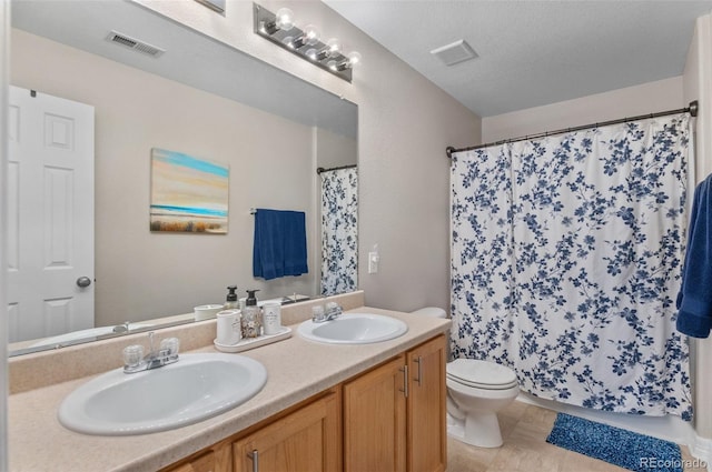 bathroom with visible vents, a sink, and toilet